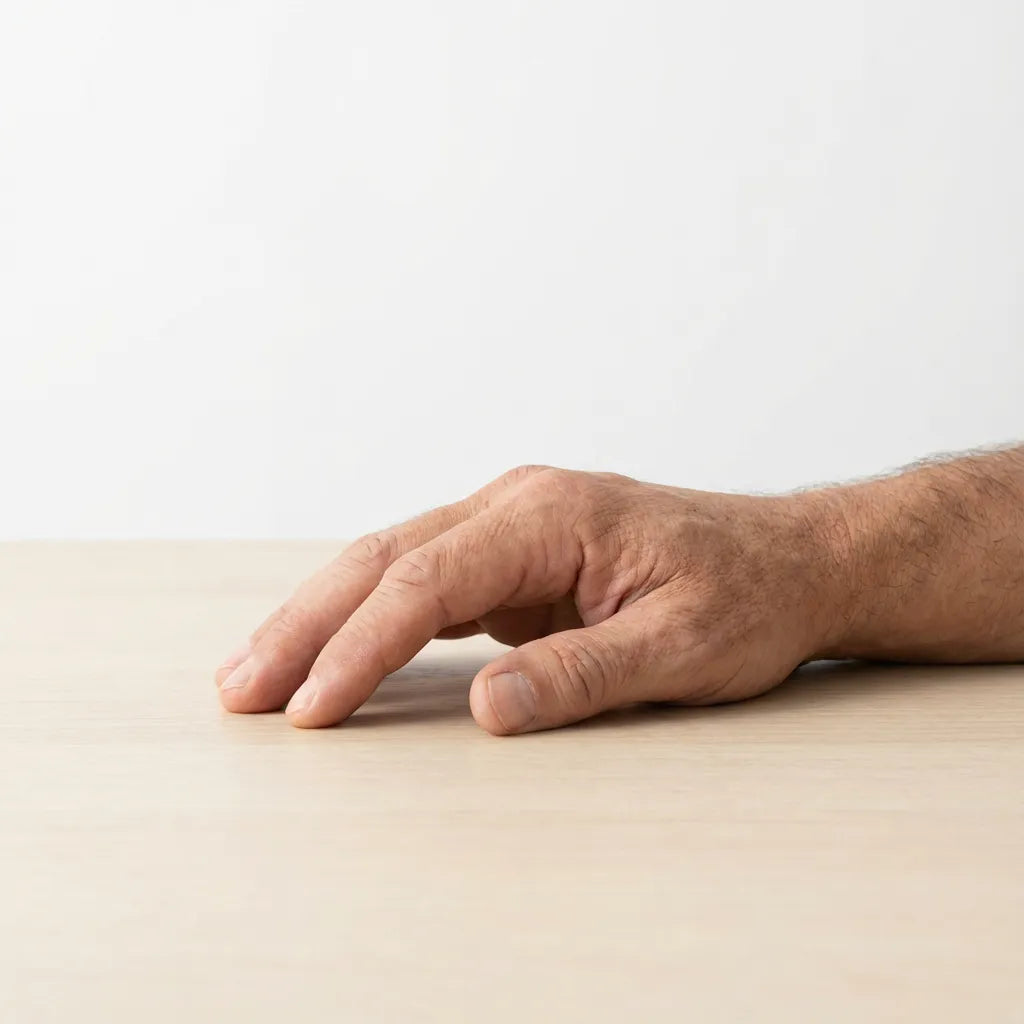 Middle-aged male hand resting calmly on a table, showing steady control, relaxed grip, and everyday confidence